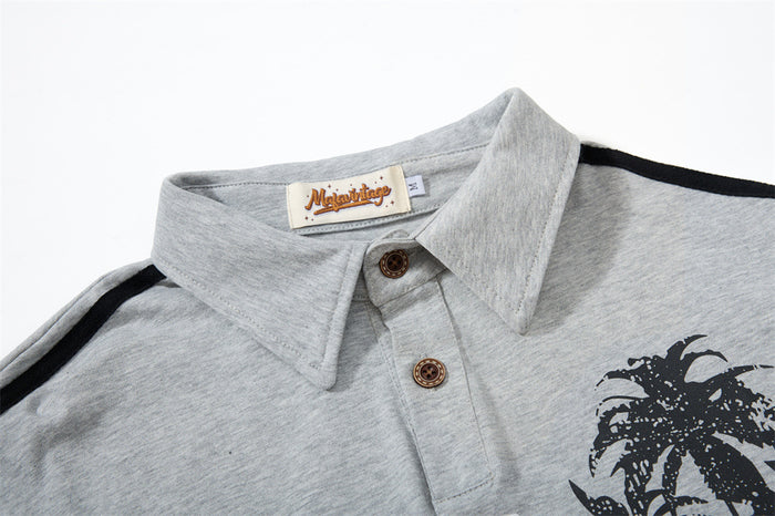 Close-up of heather gray rugby shirt collar with button placket and palm tree graphic