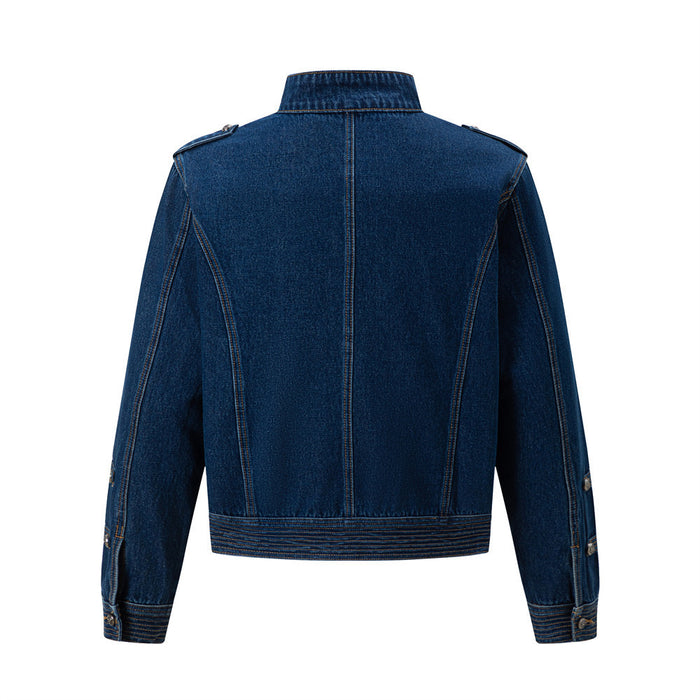 Back view of a dark blue denim jacket with a stand collar, shoulder tabs, shaped seams, and stitched hem