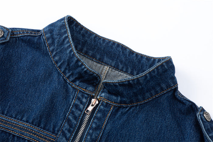 Close-up of the dark blue denim jacket's stand collar, shoulder tab, and front zipper