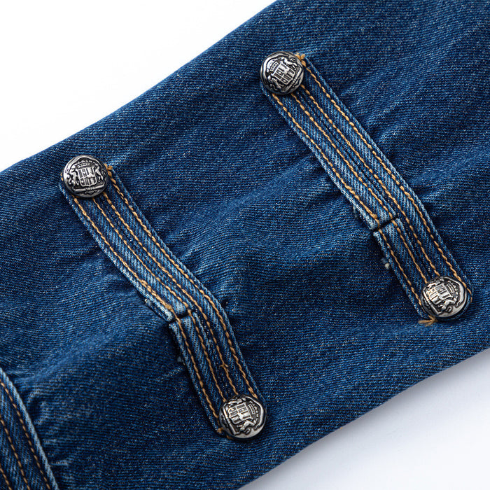 Close-up of decorative metal buttons secured by stitched denim tabs on the dark blue jacket