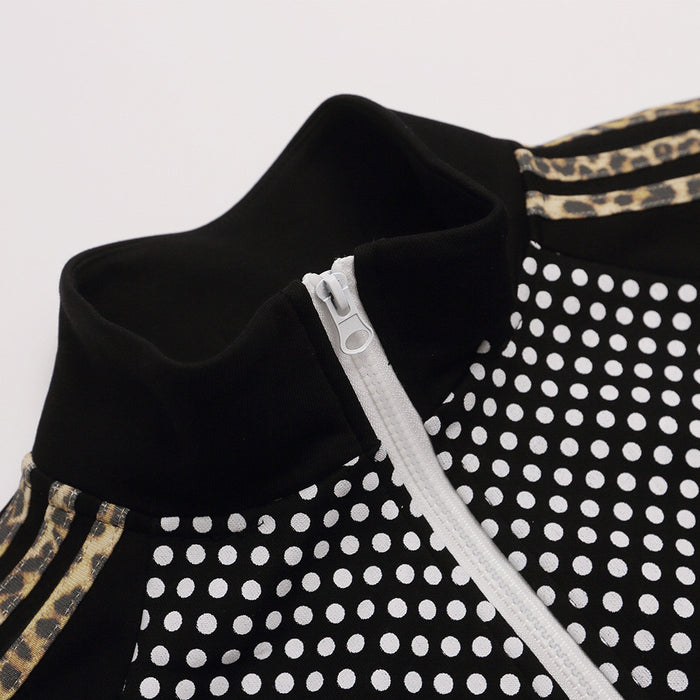 Close-up of black stand collar, white zipper, polka dot fabric, and gold-patterned shoulder stripes
