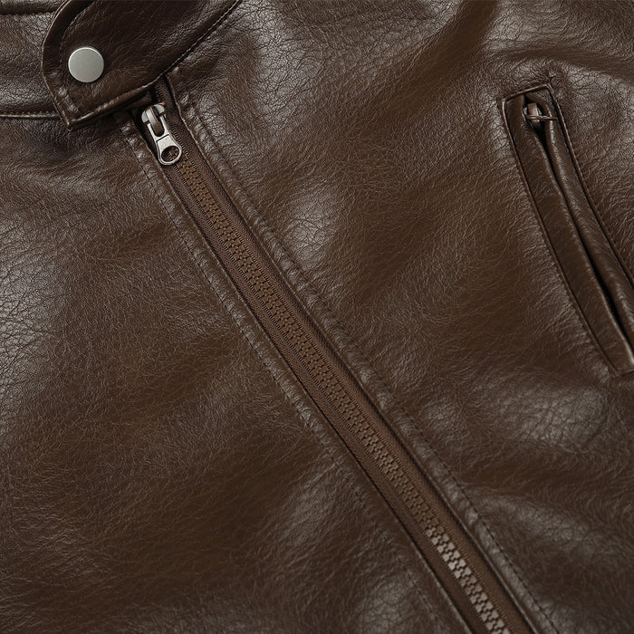 Close-up of brown PU leather jacket front showing the center zipper and angled chest pocket