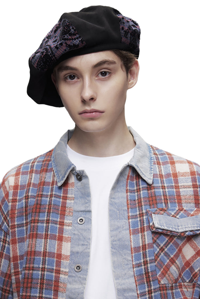 Close-up of plaid shirt collar, chest pocket, and denim-placket detail on model