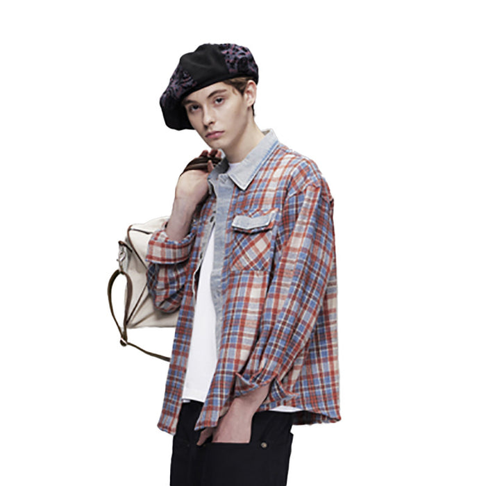 Side view of oversized red plaid shirt with denim placket and rolled sleeves