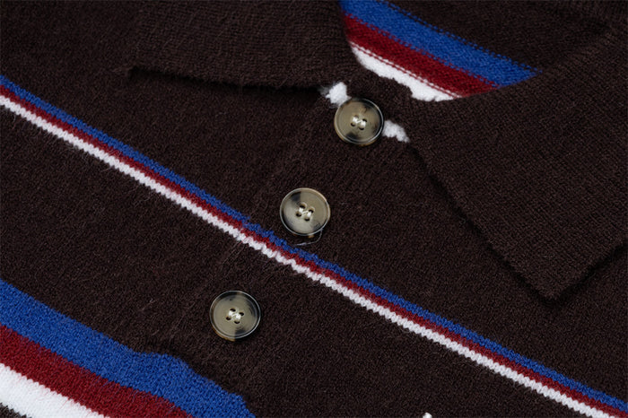 Close-up of the striped brown sweater front showing three buttons and the knitted polo placket
