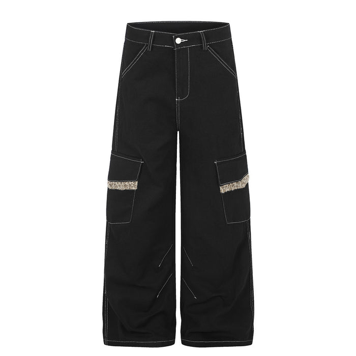 Men's wide-leg black cargo pants with leopard faux-fur trim strip and contrast white topstitching, front view