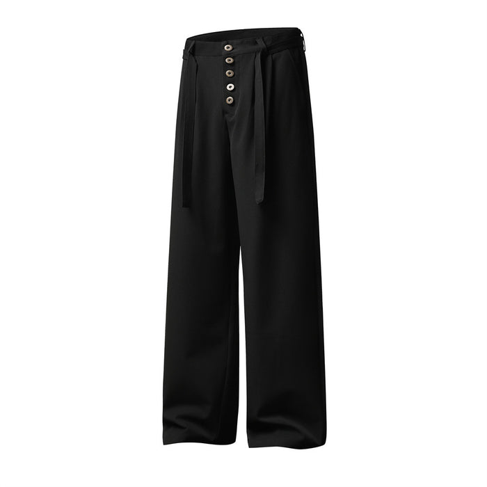 Angled front view of black wide-leg trousers highlighting the pleated waistband and button-fly closure