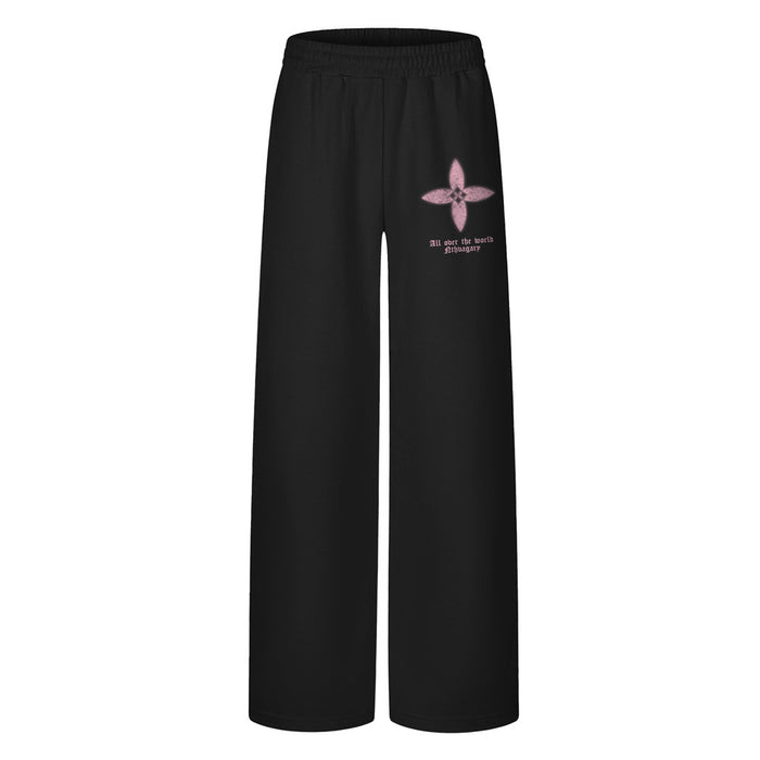 Front view of black wide-leg sweatpants with a pink four-petal floral graphic and small text