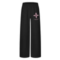 Front view of black wide-leg sweatpants with a pink four-petal floral graphic and small text