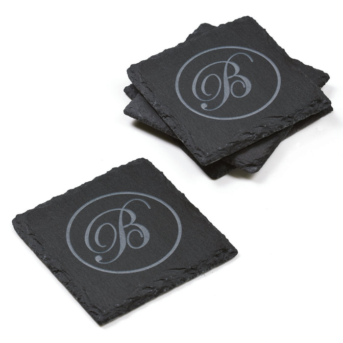 Set of four square slate coasters deep-carved with a script initial in a thin circle, on a white background.