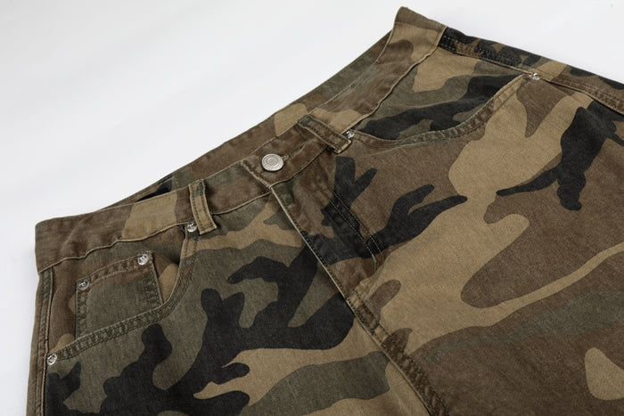 Close-up of camo denim waistband with front pocket, belt loops, and button closure