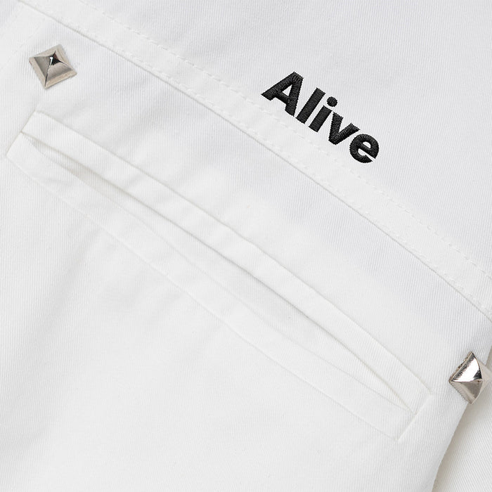 White jacket chest pocket with raised metal studs and visible black Alive embroidery