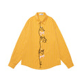 Front view of a mustard yellow vertically striped shirt with long sleeves, cat embroidery, and bow details