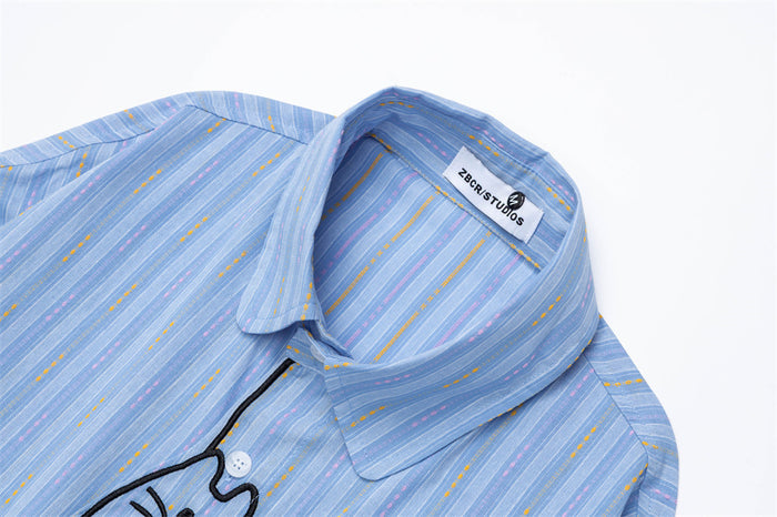 Close-up of the light blue striped shirt collar, button placket, and sewn neck label