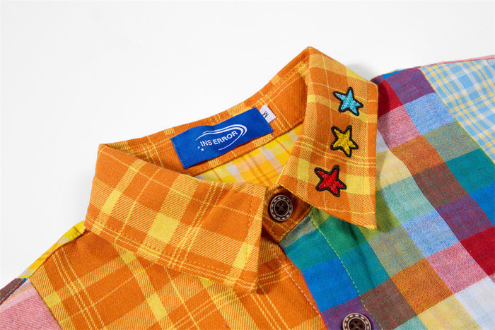 Close-up of the orange plaid collar with star patches, button closure, and a blue neck label