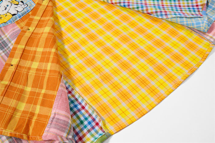 Close-up of the shirt interior and overlapping patchwork panels, including a bright yellow plaid section