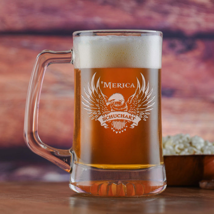 Glass beer mug filled with beer, sand-carved with an eagle with spread wings above a name, with "'Merica" above.