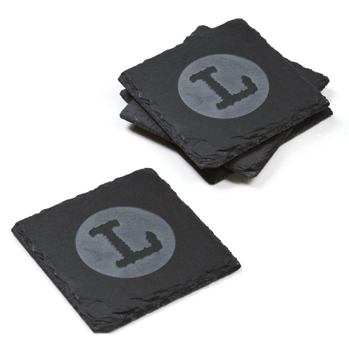 Set of four square slate coasters deep-carved with a block-letter initial in a filled circle, on a white background.