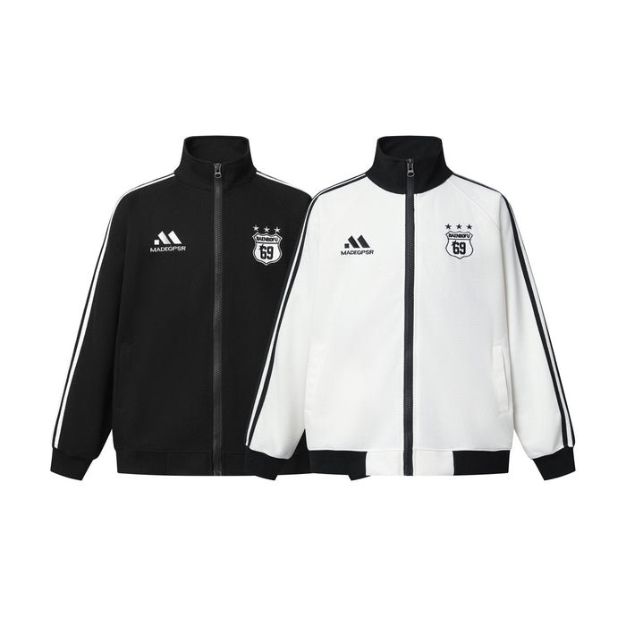Retro soccer track jacket and wide-leg track pants set in black and white with embroidered badge and three-stripe detail