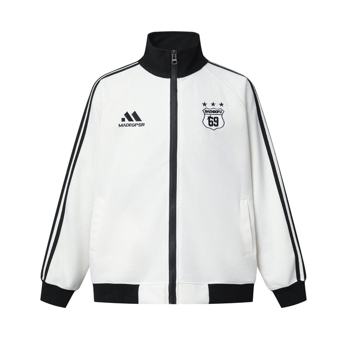 Front view of a white zip-up track jacket with black collar, cuffs, hem, stripes, and chest badges