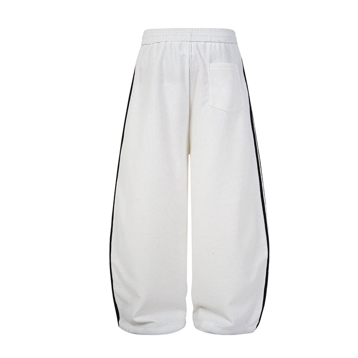 Back view of white wide-leg track pants with plain textured fabric, side stripes, and rear pocket