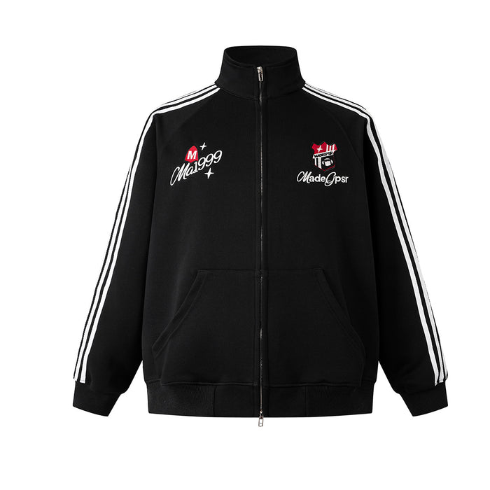 Front view of black zip-up track jacket with white three-stripe sleeves, chest badges, and side pockets