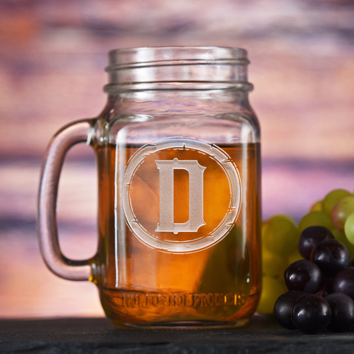 Mason jar mug with a handle, sand-carved with a single initial inside a rustic barbed-wire circle.