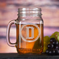Mason jar mug with a handle, sand-carved with a single initial inside a rustic barbed-wire circle.