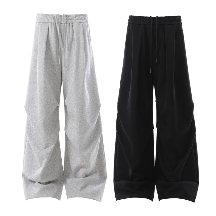 Heather grey and black sculpted 3D pleat wide-leg sweatpants with elastic drawstring waistband, shown flat on white backgroun