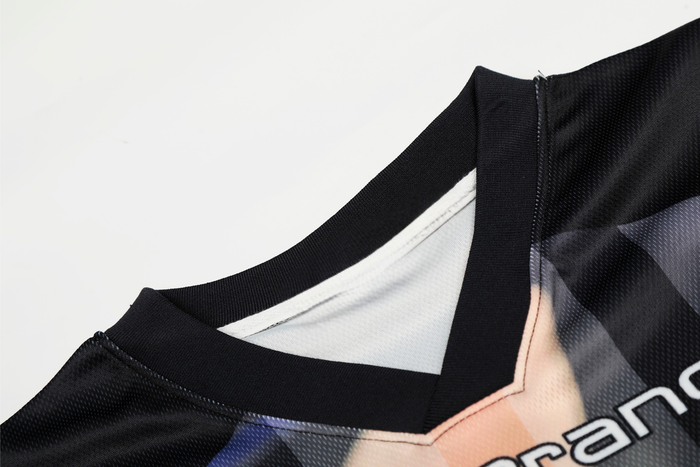 Close-up of a black mesh jersey collar with abstract portrait print and oversized streetwear styling