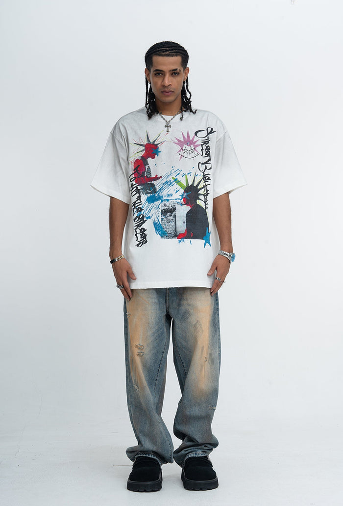 White oversized graphic T-shirt with punk street art print, worn with faded wide-leg jeans and black shoes