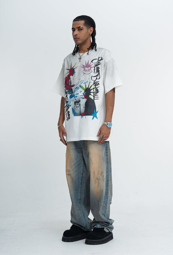 Oversized white graphic tee with bold punk graffiti print, paired with baggy faded jeans and black shoes