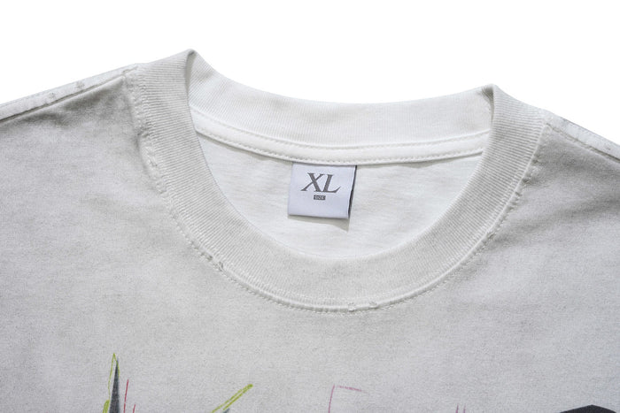 Close-up of a white crew neck graphic T-shirt with XL size label and visible punk-style print detail