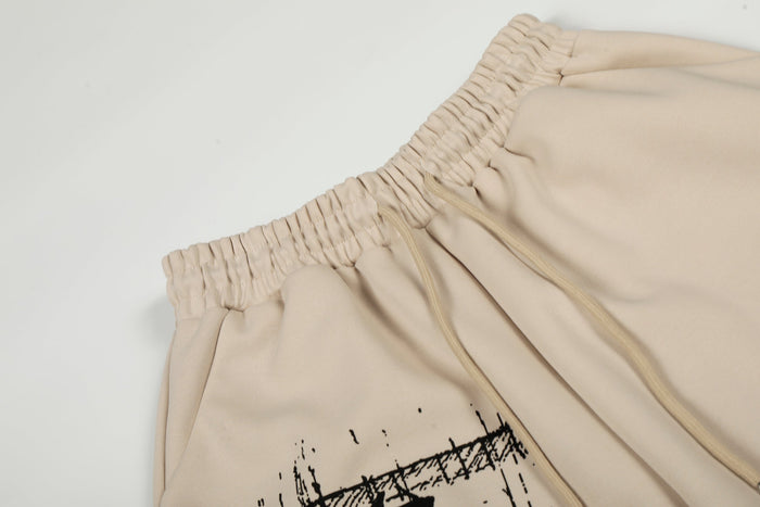 Close-up of beige elastic waistband and front drawstrings on wide-leg pants