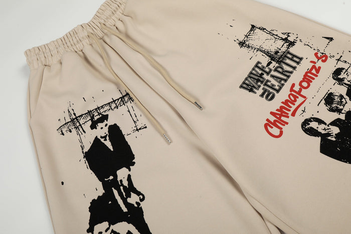 Close-up of front graphic print with black figures and red Wave to Earth text