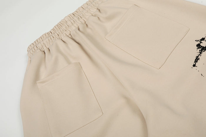 Close-up of back pockets and elastic waistband on beige wide-leg pants