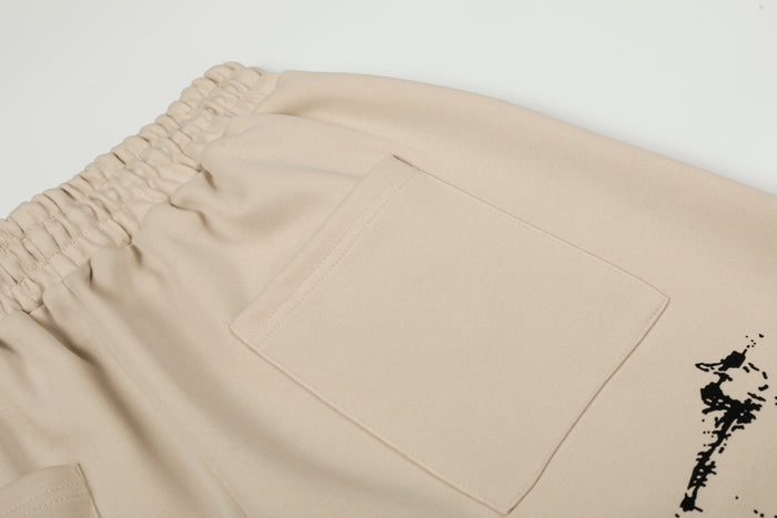 Close-up of rear pocket stitching and beige fabric texture on wide-leg pants