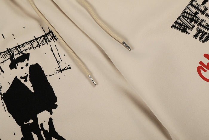 Close-up of front drawstrings and Wave to Earth graphic on beige pants