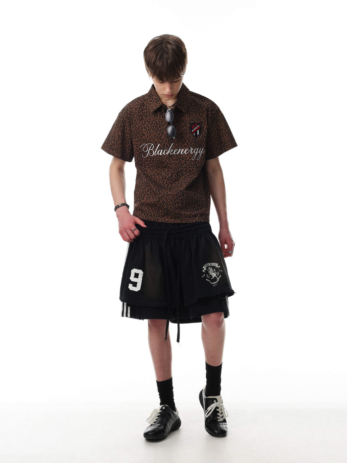 Brown leopard print polo tee with script logo and short sleeves, styled on a model with streetwear shorts and black shoes