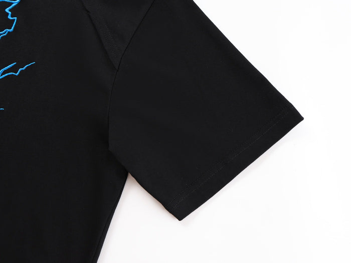 Black oversized graphic tee with blue lightning embroidery and short sleeve on white background