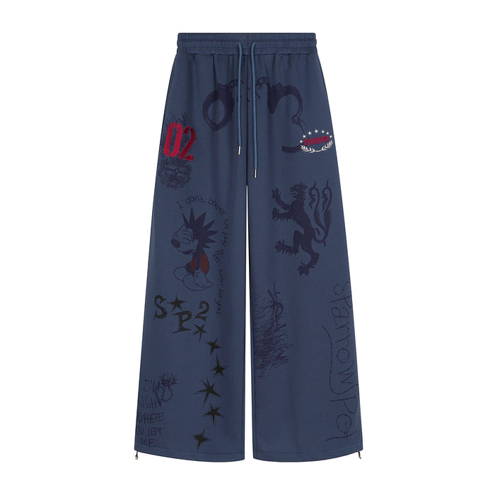 Front view of navy wide-leg sweatpants with sketch-style graphics and drawstring waist