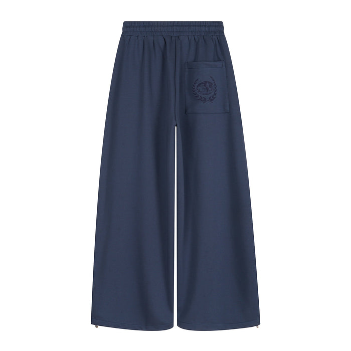 Back view of navy wide-leg sweatpants with a single patch pocket and subtle graphic print
