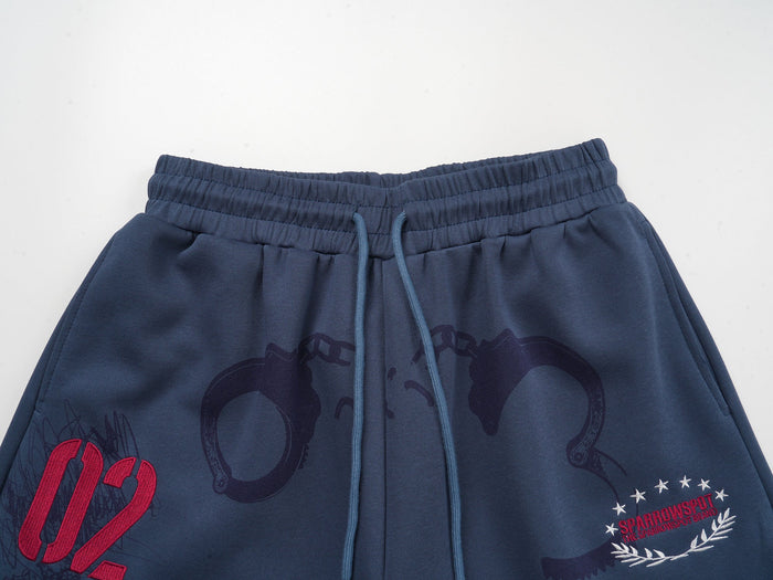 Close-up of the sweatpants waistband with blue drawstrings and printed graphic details