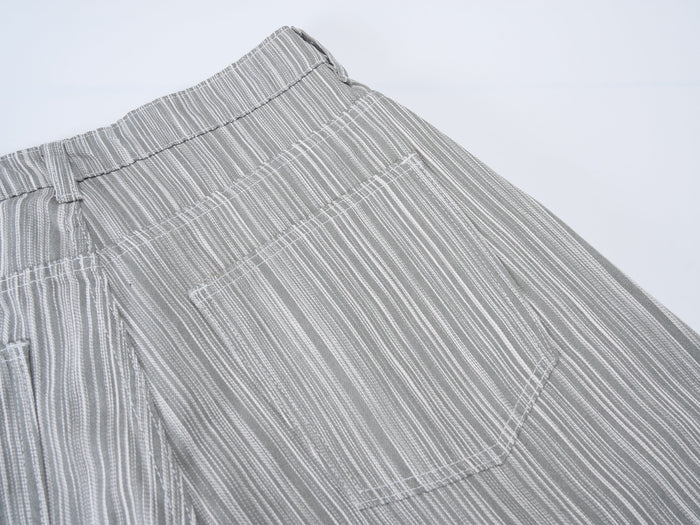 Back waistband close-up showing striped fabric, belt loops, and patch pocket stitching