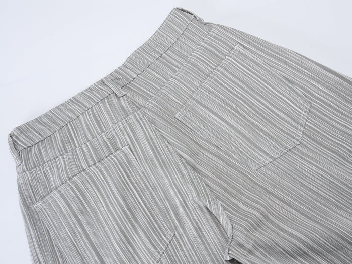 Back pocket close-up on gray striped pants with visible seam and stitch detail