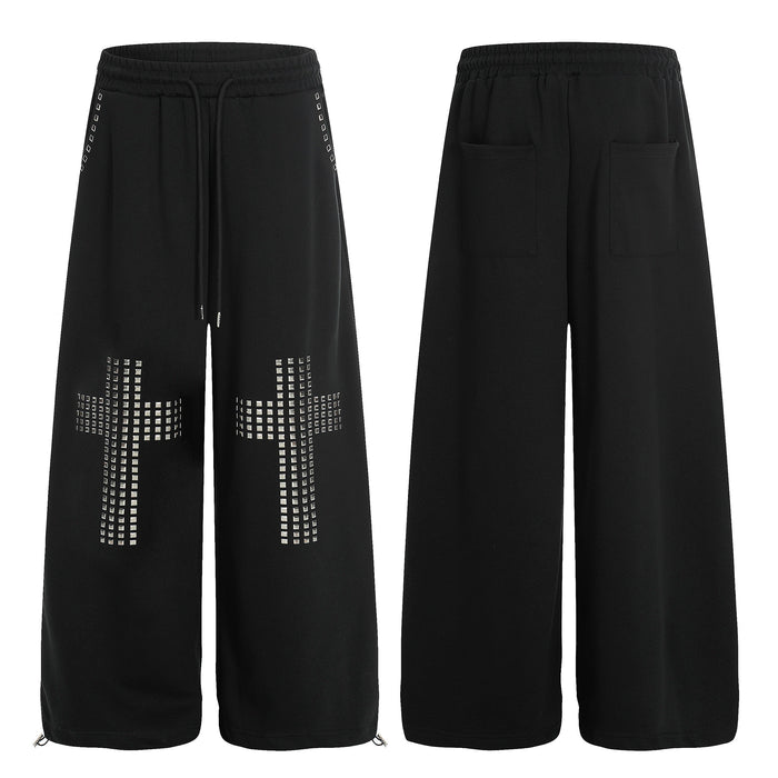 Black wide-leg sweatpants with square metal stud cross motifs on each leg, front and back view