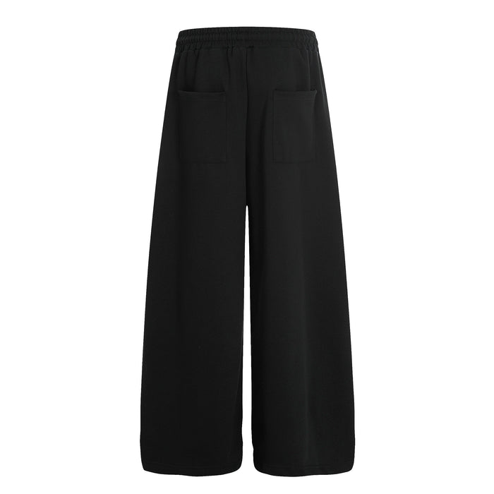 Back view of black wide-leg sweatpants with plain rear pockets and elastic waistband