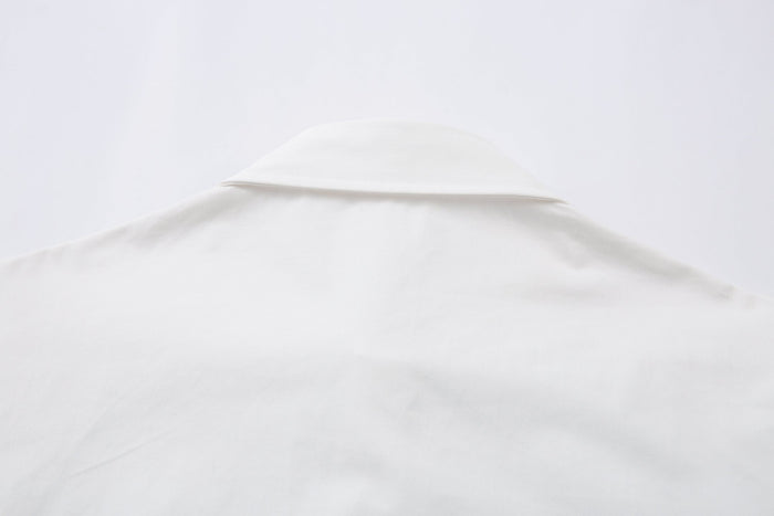 Close-up of white shirt collar and upper back seam