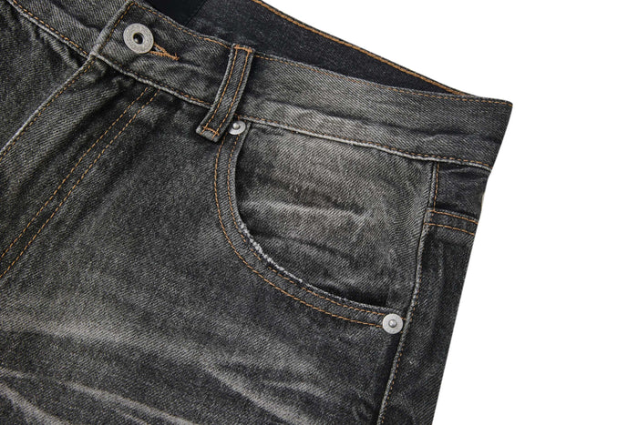 Close-up of front right pocket on faded black jeans with coin pocket and contrast stitching