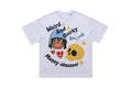 White graphic tee with quirky money-obsessed print, cartoon face, skull, and bold streetwear lettering
